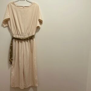 Cream short sleeve one-piece pant suit.